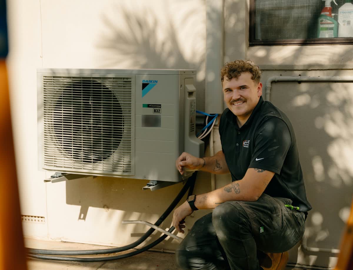 James beside a newly installed split system outdoor unit