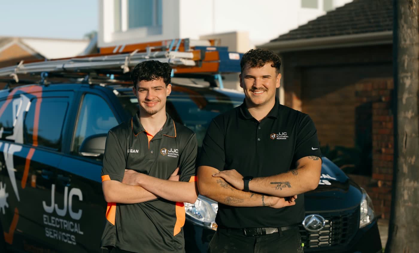 James and Logan from JJC Electrical beside the work van