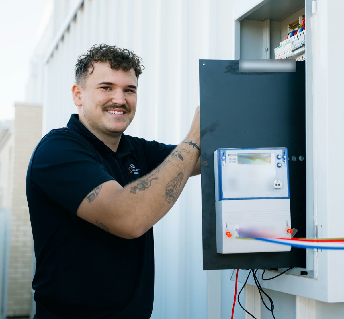 James from JJC Electrical at a meter box and switchboard